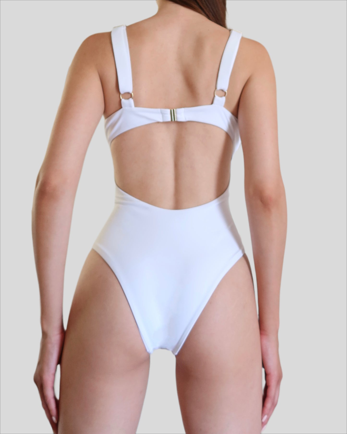 White luxury one-piece swimwear for women made in Italy with gold accessories in recycled lycra econyl