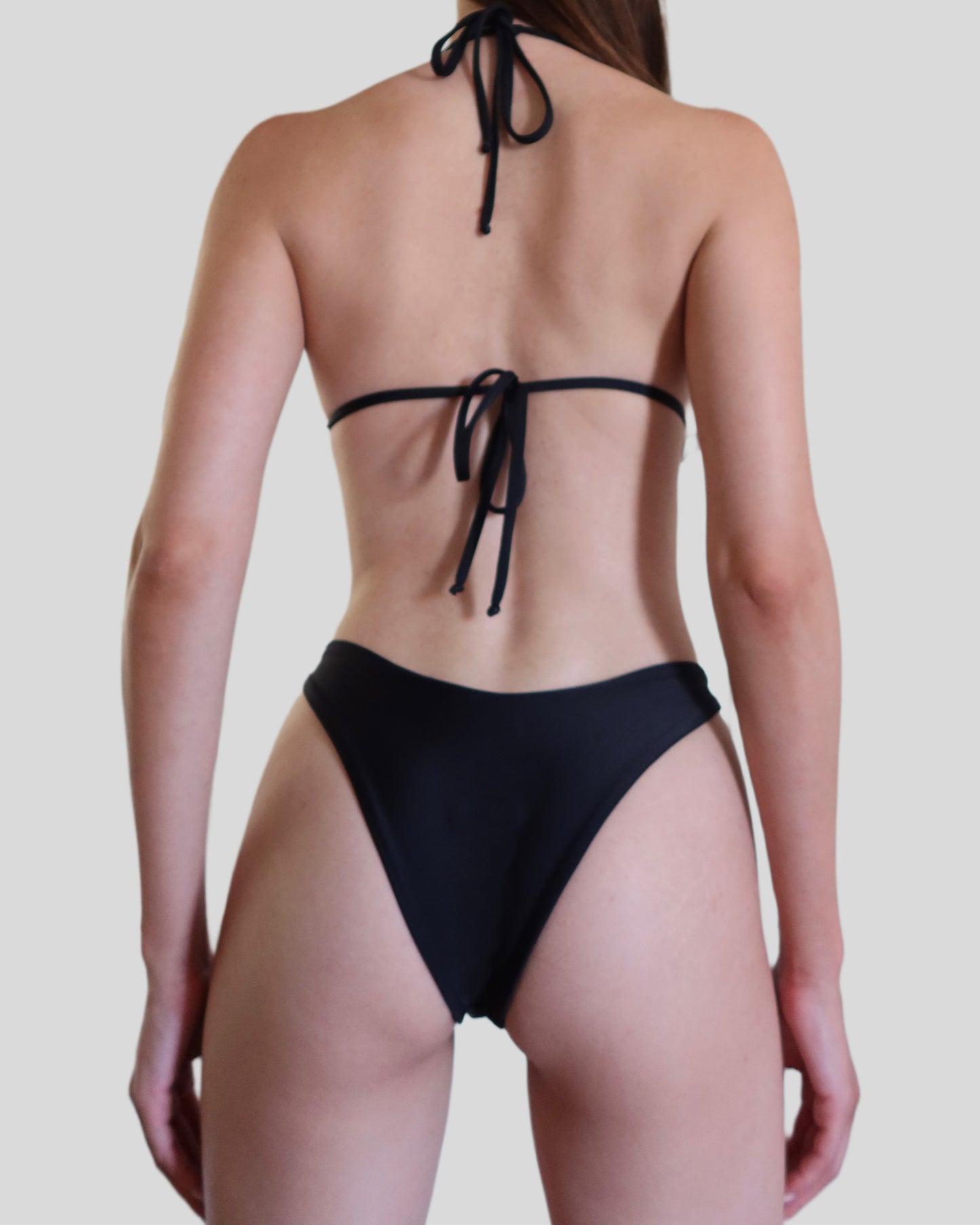 Black luxury swimwear for women made in Italy with gold accessories in recycled lycra econyl